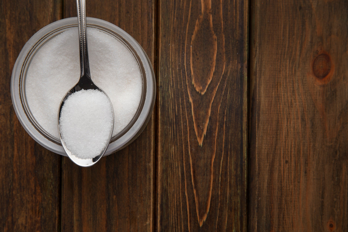 Bottle of Block glucose disposal agent capsules beside a carbohydrate-rich meal